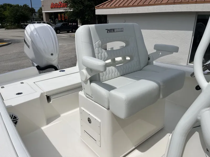 Slide: The Image of The image shows the seating area of a Pathfinder 2400 Hybrid boat with white upholstery. - 21