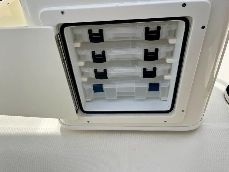 Slide: The Image of An open storage compartment with several transparent plastic containers inside. - 29