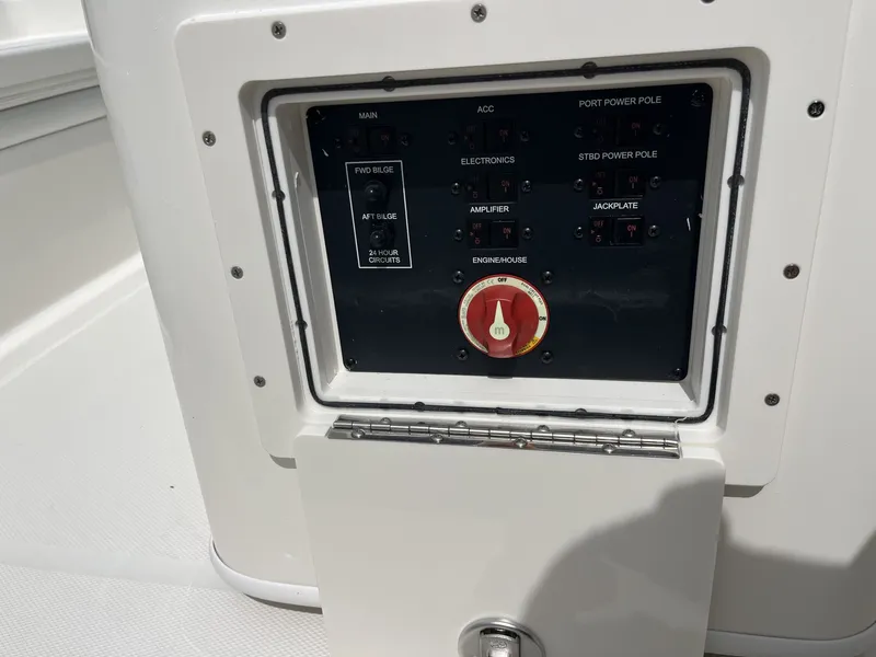 Slide: The Image of A control panel on a boat with various switches and a large red rotary knob. - 30