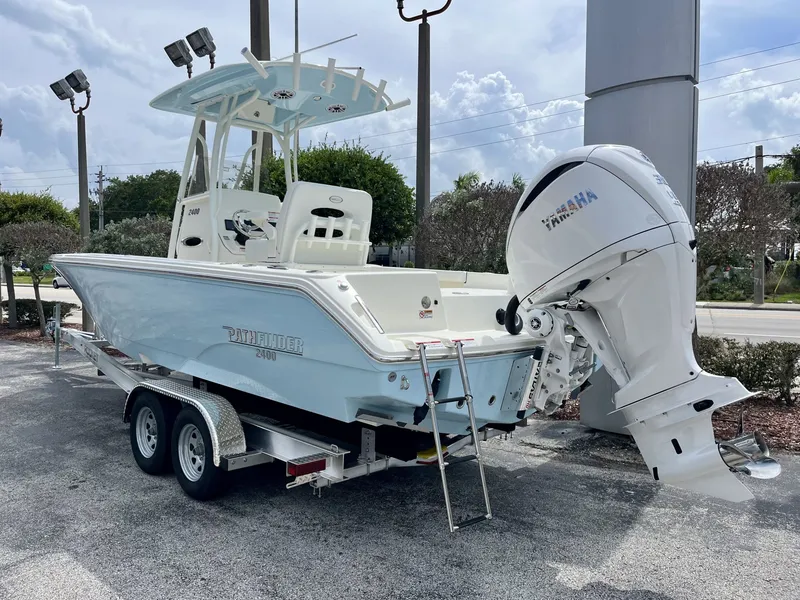 Slide: The Image of A modern Pathfinder 2400 Hybrid on a trailer, featuring a large outboard motor. - 6