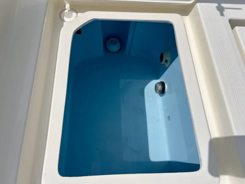 Slide: The Image of An open storage compartment on a boat with a blue interior. - 23
