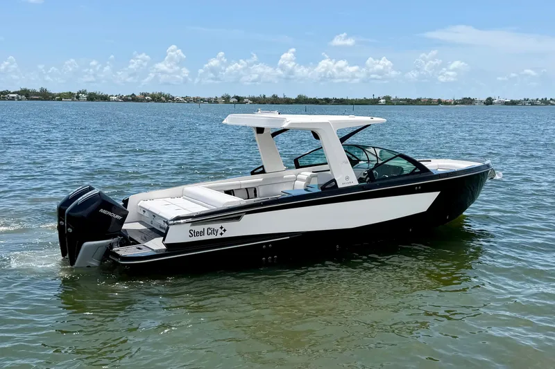 Slide: The Image of 2022 Aviara AV32 OB boat on calm water under clear blue sky. - 10