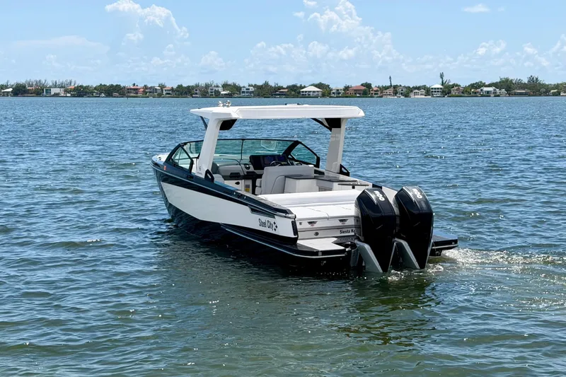 Slide: The Image of 2022 Aviara AV32 OB boat cruising on a sunny day with twin outboard engines. - 11