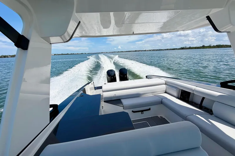 Slide: The Image of 2022 Aviara AV32 OB cruising on open water, showcasing luxurious seating and powerful engines. - 13