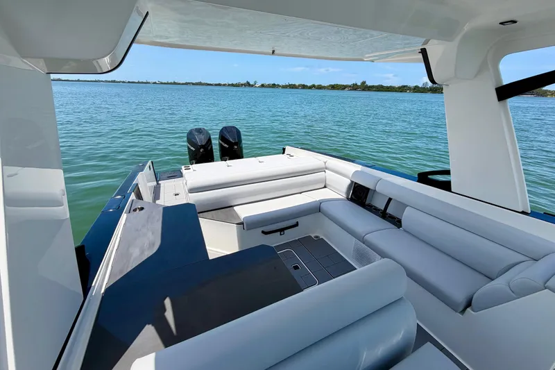 Slide: The Image of 2022 Aviara AV32 OB luxury boat interior with spacious seating on calm water. - 15