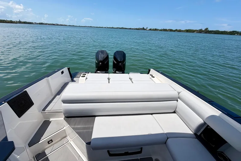 Slide: The Image of 2022 Aviara AV32 OB boat with dual outboard motors on a serene water backdrop. - 16