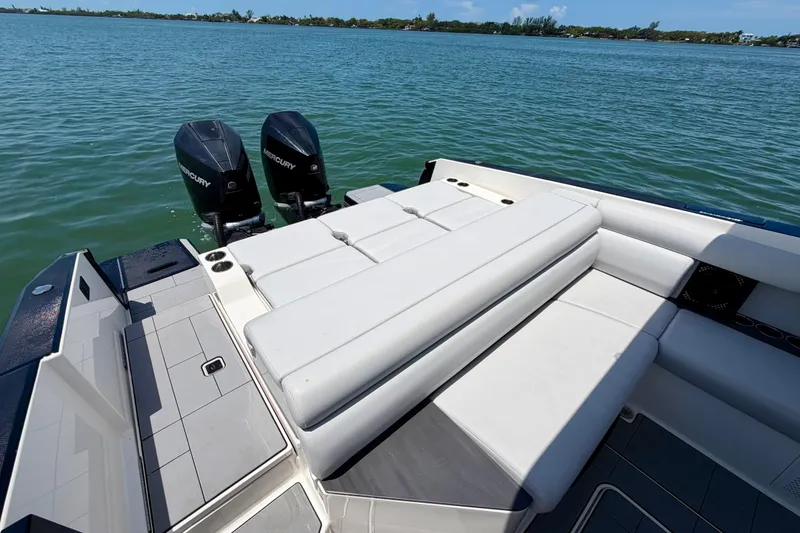 Slide: The Image of 2022 Aviara AV32 OB boat with dual Mercury outboard engines on a serene lake. - 17