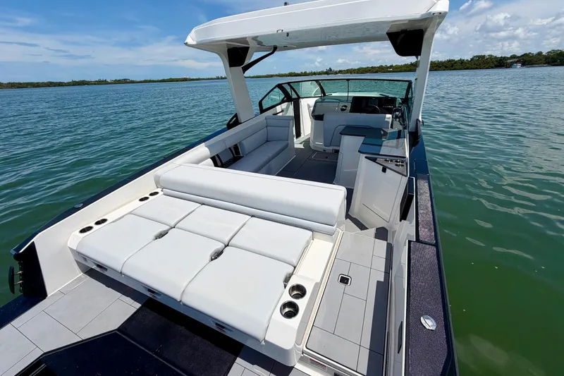 Slide: The Image of 2022 Aviara AV32 OB luxury boat with spacious seating on a serene lake. - 18