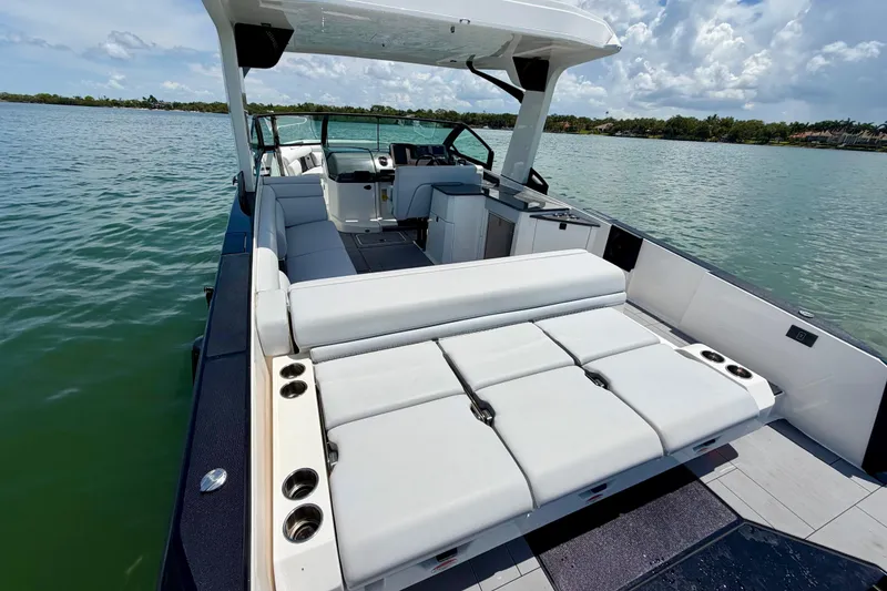 Slide: The Image of 2022 Aviara AV32 OB luxury boat interior with spacious seating on a calm lake. - 19