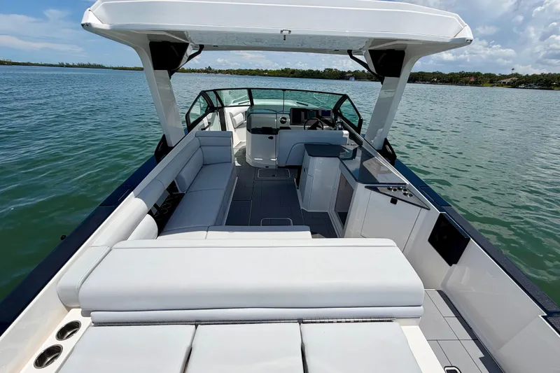 Slide: The Image of 2022 Aviara AV32 OB luxury boat interior with spacious seating on a serene lake. - 20