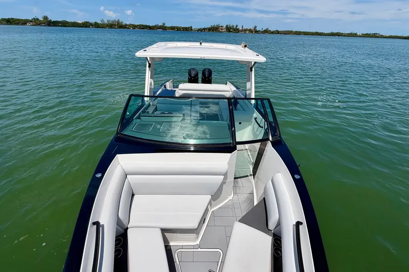 Slide: The Image of 2022 Aviara AV32 OB boat on calm water, featuring sleek design and spacious seating. - 22