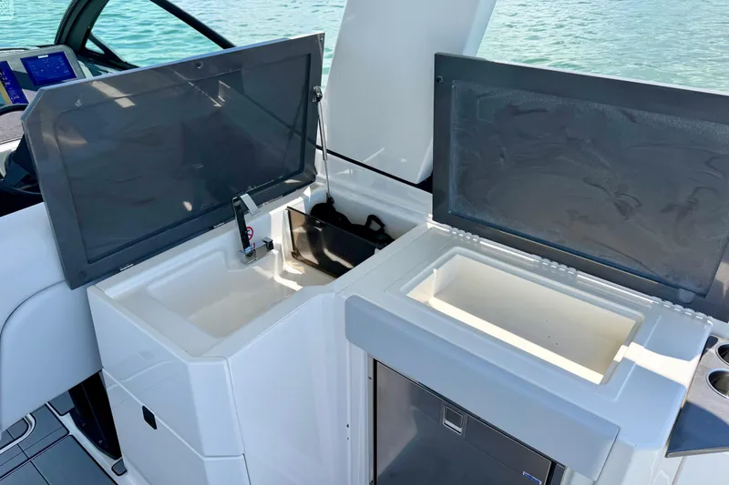 Slide: The Image of Aviara AV32 OB 2022 boat interior with open storage compartments and sink. - 29