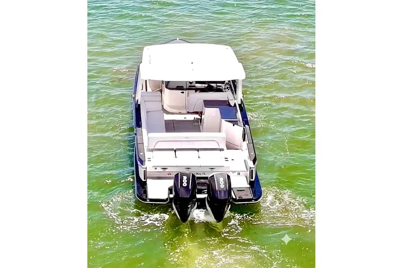 Slide: The Image of 2022 Aviara AV32 OB boat with dual outboard engines on clear water. - 3