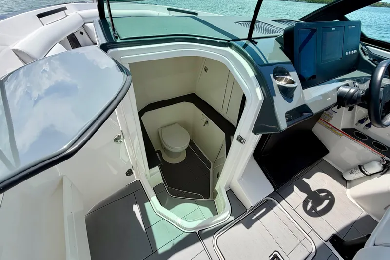 Slide: The Image of 2022 Aviara AV32 OB boat interior with helm and cabin entrance. - 34