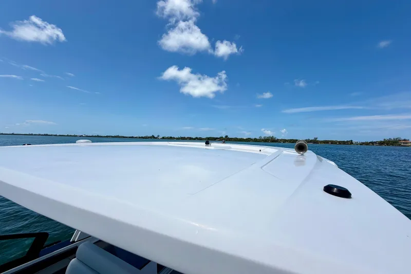 Slide: The Image of 2022 Aviara AV32 OB boat on calm water under clear blue sky. - 37