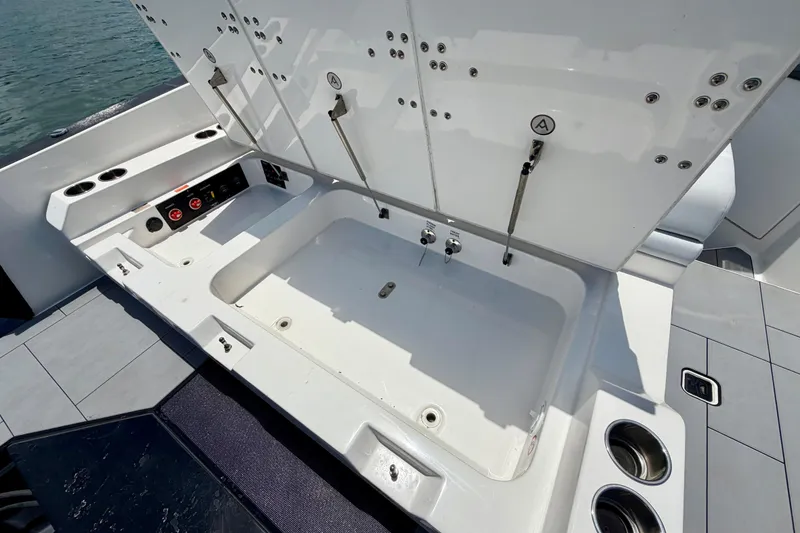 Slide: The Image of 2022 Aviara AV32 OB boat with open storage compartment and cup holders on deck. - 39
