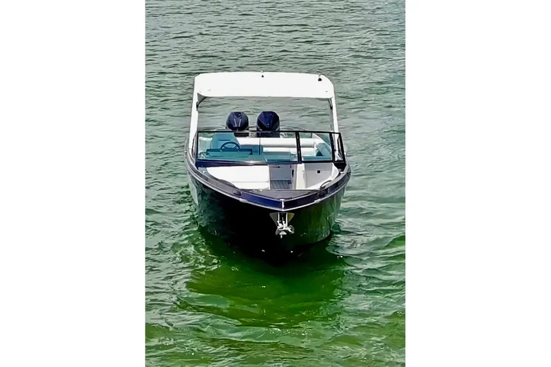 Slide: The Image of Front view of a 2022 Aviara AV32 OB boat on calm water. - 4