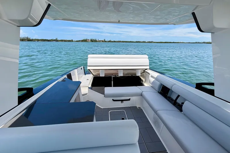 Slide: The Image of 2022 Aviara AV32 OB boat interior with luxurious seating on a serene water backdrop. - 40