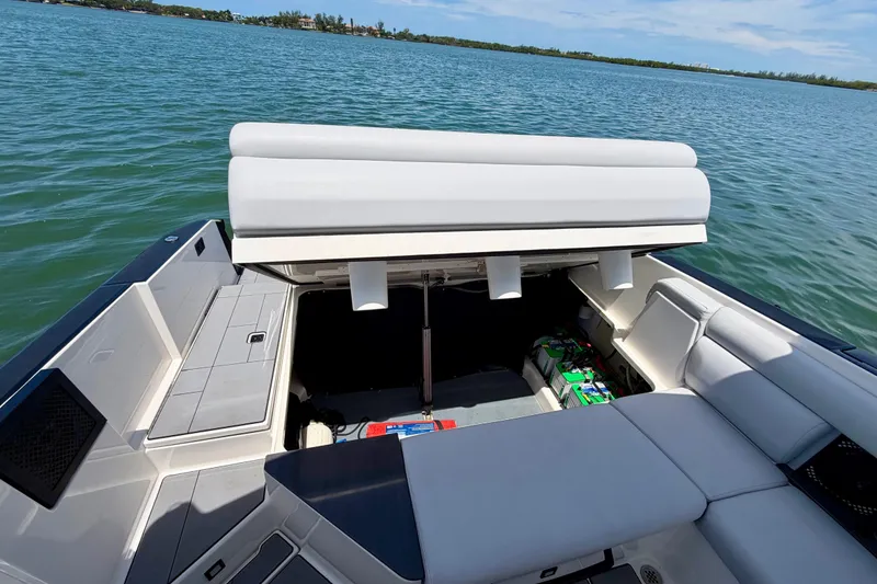 Slide: The Image of 2022 Aviara AV32 OB boat with open storage compartment on a sunny day. - 41