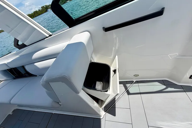 Slide: The Image of 2022 Aviara AV32 OB boat interior with open storage compartment and sleek seating. - 47