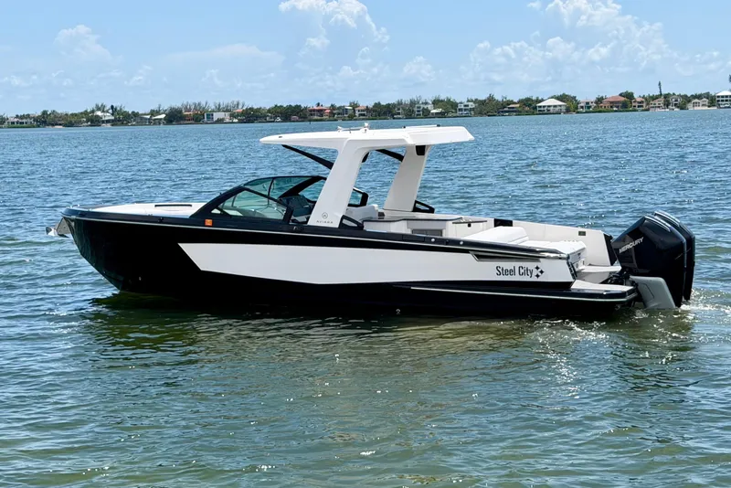 Slide: The Image of 2022 Aviara AV32 OB boat on calm water, featuring sleek design and modern outboard engines. - 5