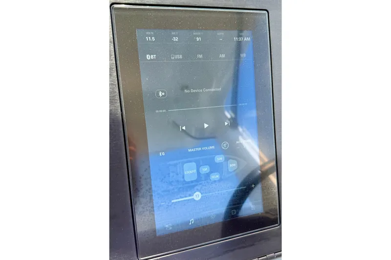 Slide: The Image of Touchscreen control panel on 2022 Aviara AV32 OB boat, displaying audio settings and connectivity options. - 52