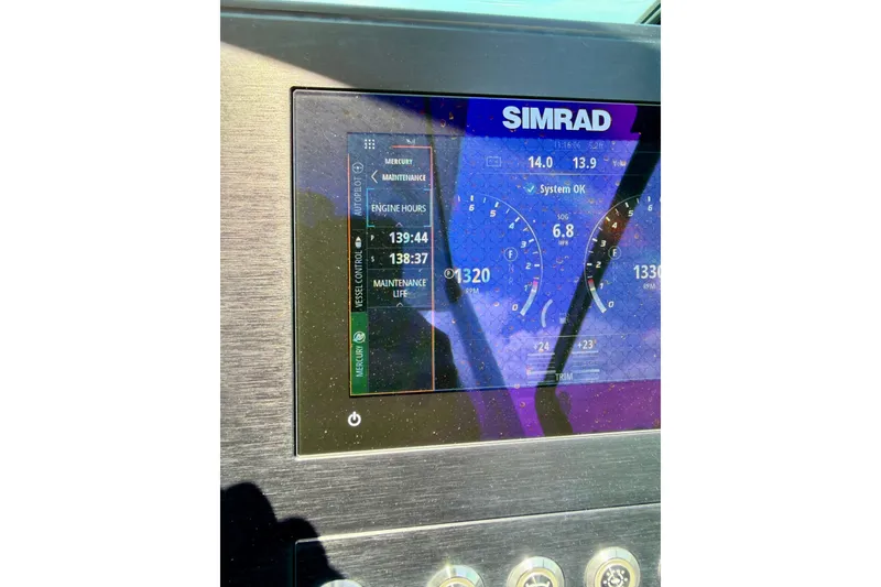 Slide: The Image of Simrad display on 2022 Aviara AV32 OB showing engine hours and system status. - 53