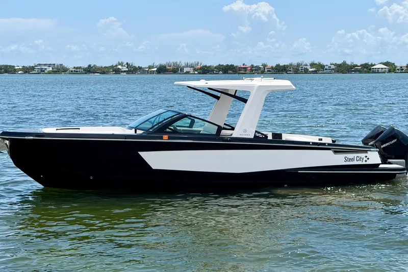 Slide: The Image of 2022 Aviara AV32 OB boat on calm water, featuring sleek black and white design. - 6