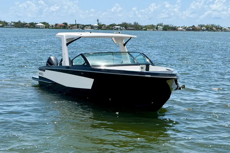 Slide: The Image of 2022 Aviara AV32 OB boat on calm water under a clear sky. - 8