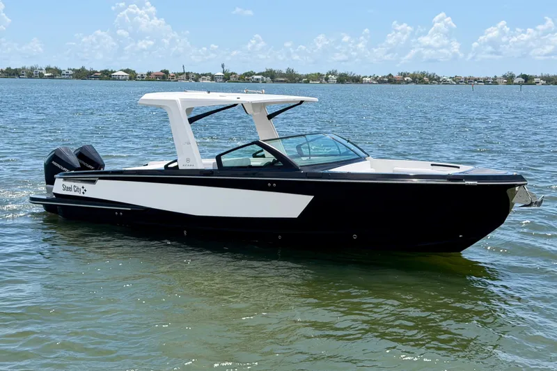 Slide: The Image of 2022 Aviara AV32 OB boat on calm water under a clear sky. - 9