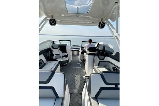 Slide: The Image of Luxurious 2021 Yamaha Boats 275SD interior with modern seating and helm on open water. - 20
