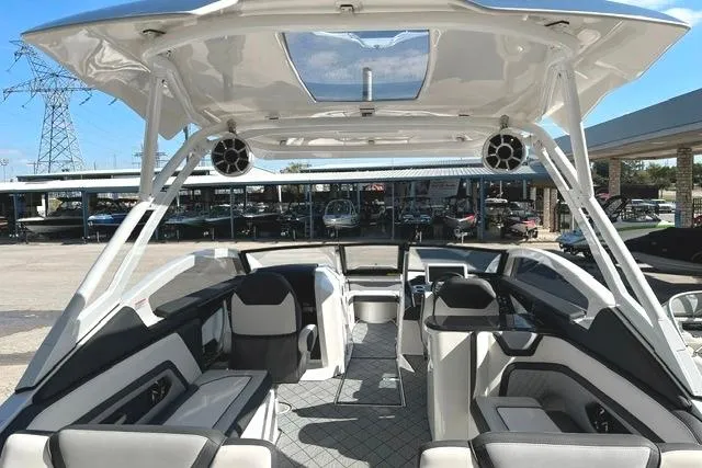 Slide: The Image of 2021 Yamaha Boats 275SD interior with modern seating and sleek design under a clear sky. - 22