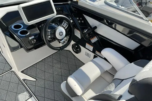 Slide: The Image of 2021 Yamaha Boats 275SD cockpit with modern steering, touchscreen, and comfortable seating. - 27
