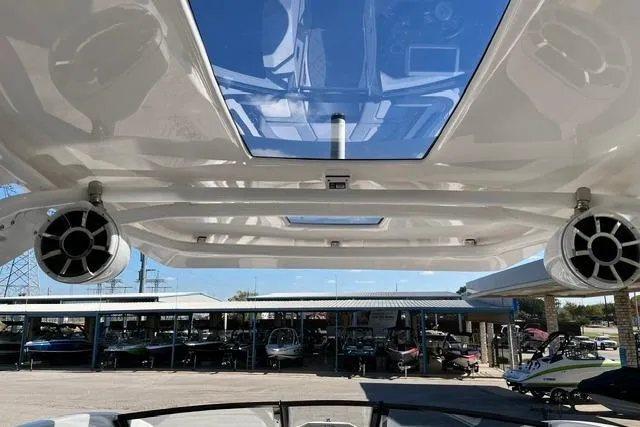 Slide: The Image of 2021 Yamaha Boats 275SD interior view with speakers and sunroof, showcasing modern design. - 37