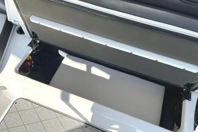 Slide: The Image of 2021 Yamaha Boats 275SD storage compartment with open seat revealing interior space. - 38