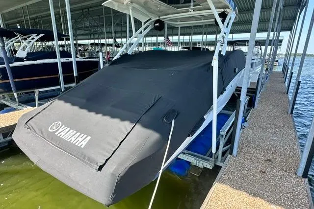 Slide: The Image of 2021 Yamaha Boats 275SD covered in a dock, showcasing sleek design and protection. - 7