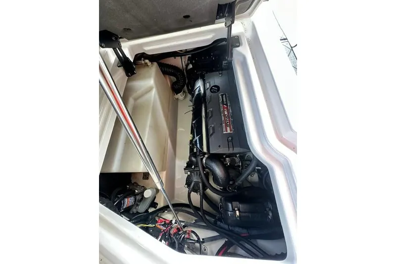 Slide: The Image of Engine compartment of a 2021 Yamaha Boats 275SD, showcasing mechanical components and wiring. - 8