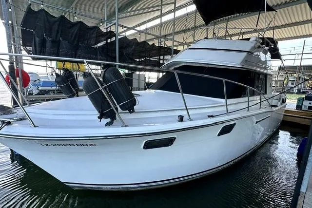 Slide: The Image of 1989 Carver 32 Aft Cabin Motor Yacht docked in marina. - 1