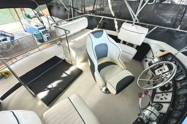 Slide: The Image of 1989 Carver 32 Aft Cabin Motor Yacht helm with seating and steering wheel. - 10