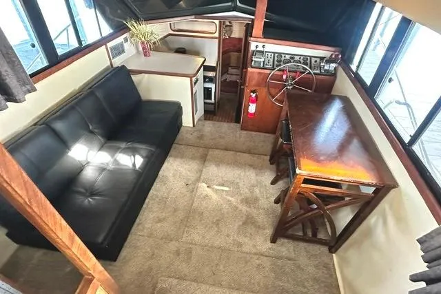 Slide: The Image of Interior of 1989 Carver 32 Aft Cabin Motor Yacht with sofa and helm station. - 12