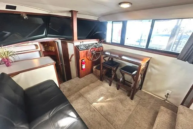 Slide: The Image of Interior of 1989 Carver 32 Aft Cabin Motor Yacht with seating and helm. - 13