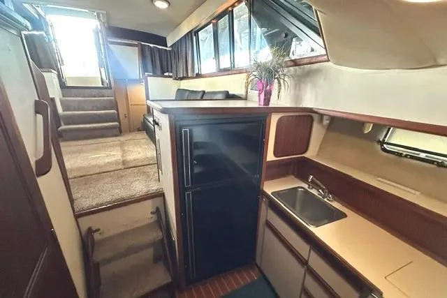 Slide: The Image of Interior of 1989 Carver 32 Aft Cabin Motor Yacht with kitchenette and seating area. - 17