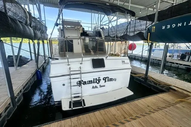 Slide: The Image of 1989 Carver 32 Aft Cabin Motor Yacht docked, named "Family Time," in a marina setting. - 2
