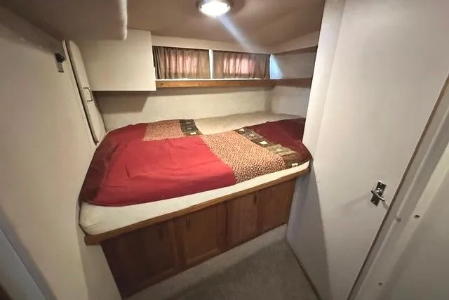 Slide: The Image of Cozy cabin bedroom in 1989 Carver 32 Aft Cabin Motor Yacht with red bedding. - 21