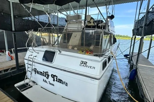 Slide: The Image of 1989 Carver 32 Aft Cabin Motor Yacht docked, featuring "Family Time" name on the stern. - 3