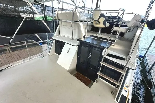 Slide: The Image of 1989 Carver 32 Aft Cabin Motor Yacht with upper deck seating and helm station. - 6