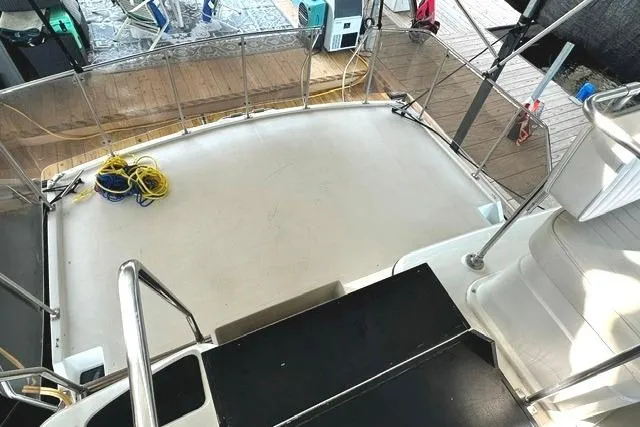 Slide: The Image of 1989 Carver 32 Aft Cabin Motor Yacht deck with railing and coiled ropes. - 8