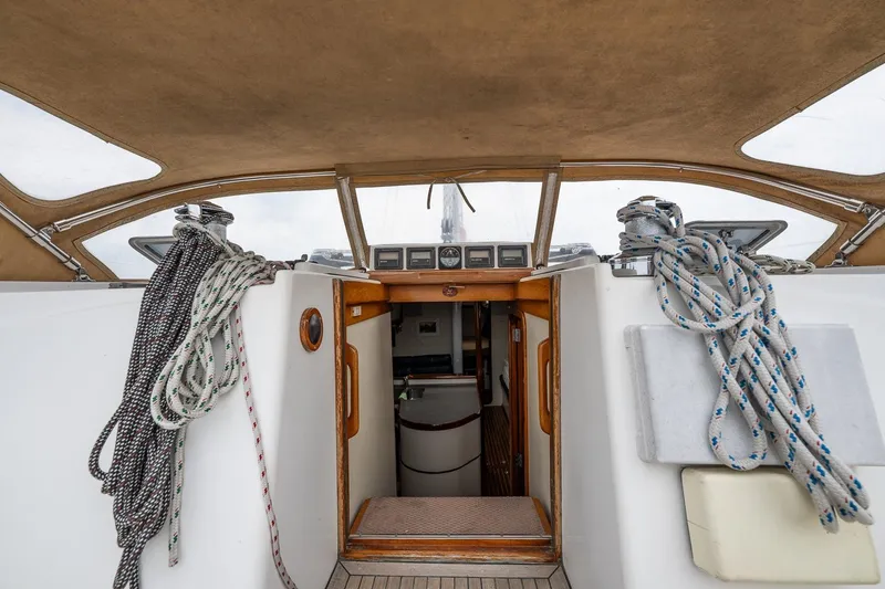 Slide: The Image of Cockpit view of 1992 Morris Ocean Series 44 sailboat with ropes and wooden interior. - 22