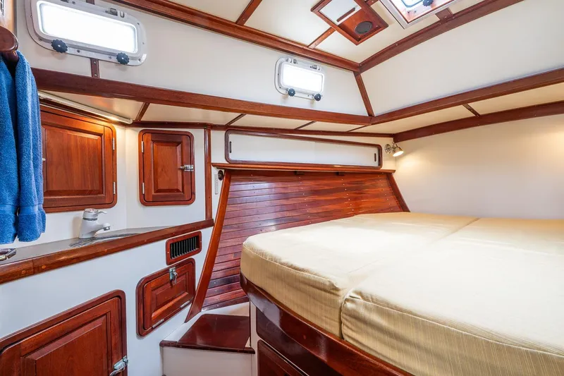 Slide: The Image of Luxurious cabin interior of 1992 Morris Ocean Series 44 yacht with wooden accents and cozy bed. - 35