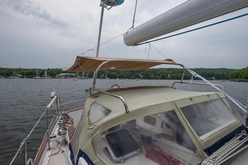 Slide: The Image of Sailboat Morris Ocean Series 44, 1992 model, anchored on a calm lake with canopy. - 57